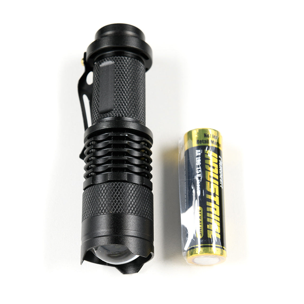 Black safety flashlight with knurled grip and a yellow battery, part of the Hoonigan OH SH*T Safety Kit.
