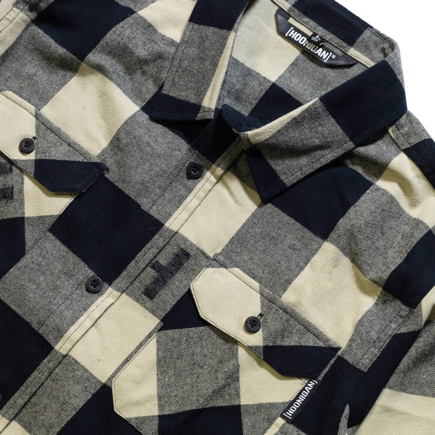 Black and red Hoonigan H Icon woven flannel long sleeve shirt with a plaid pattern and logo patch.