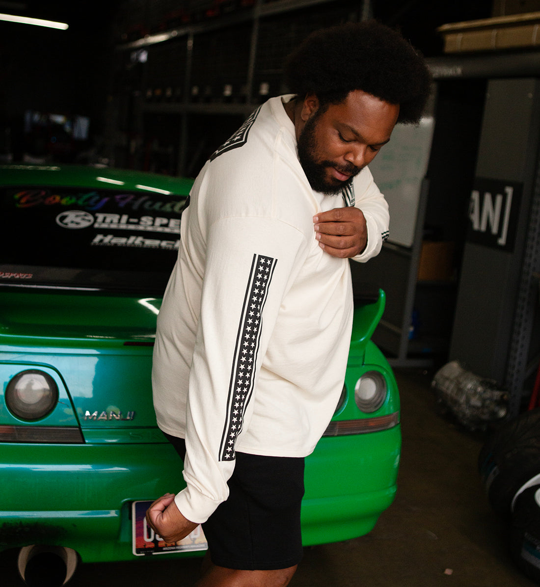 Hoonigan HARDTAIL Long Sleeve Tee displayed in a natural setting, featuring a casual fit with logo graphics.