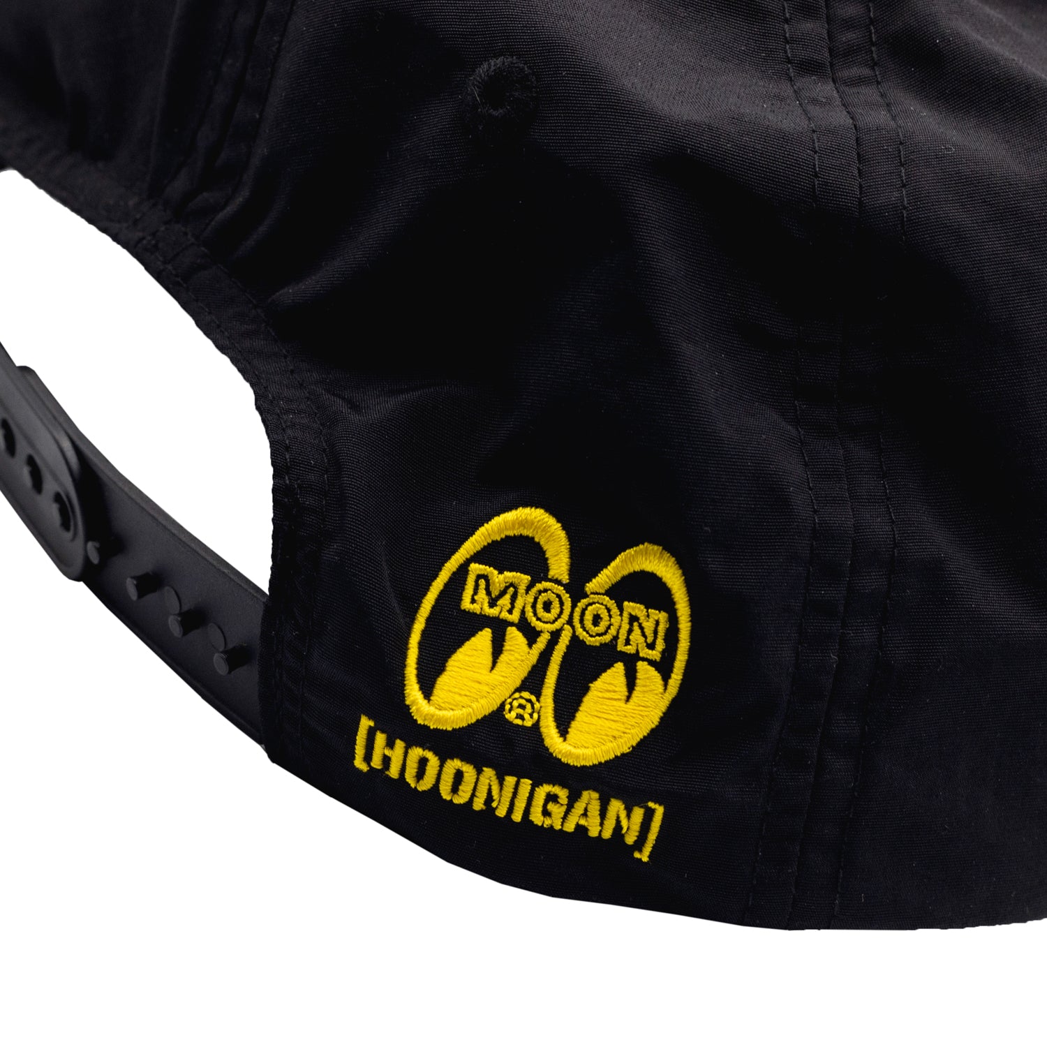 Hoonigan x Mooneyes unstructured snapback hat featuring a decorated front patch and adjustable strap, displayed on a neutral background.