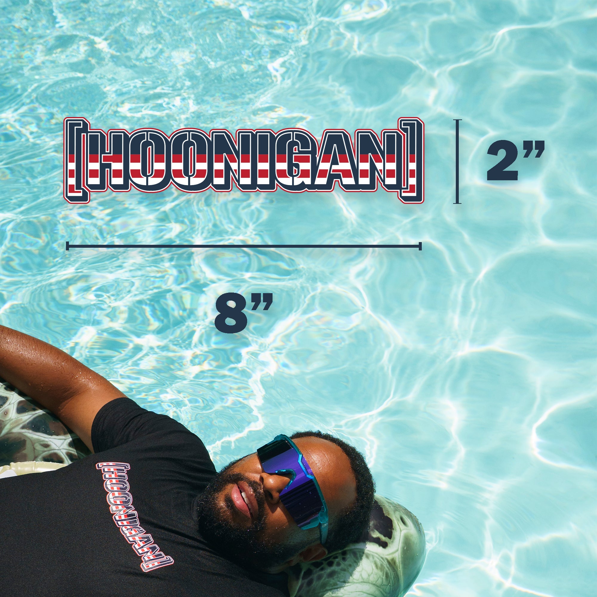 Hoonigan USA sticker measuring 8 inches by 2 inches, featuring bold red, white, and blue design, displayed over a pool background.