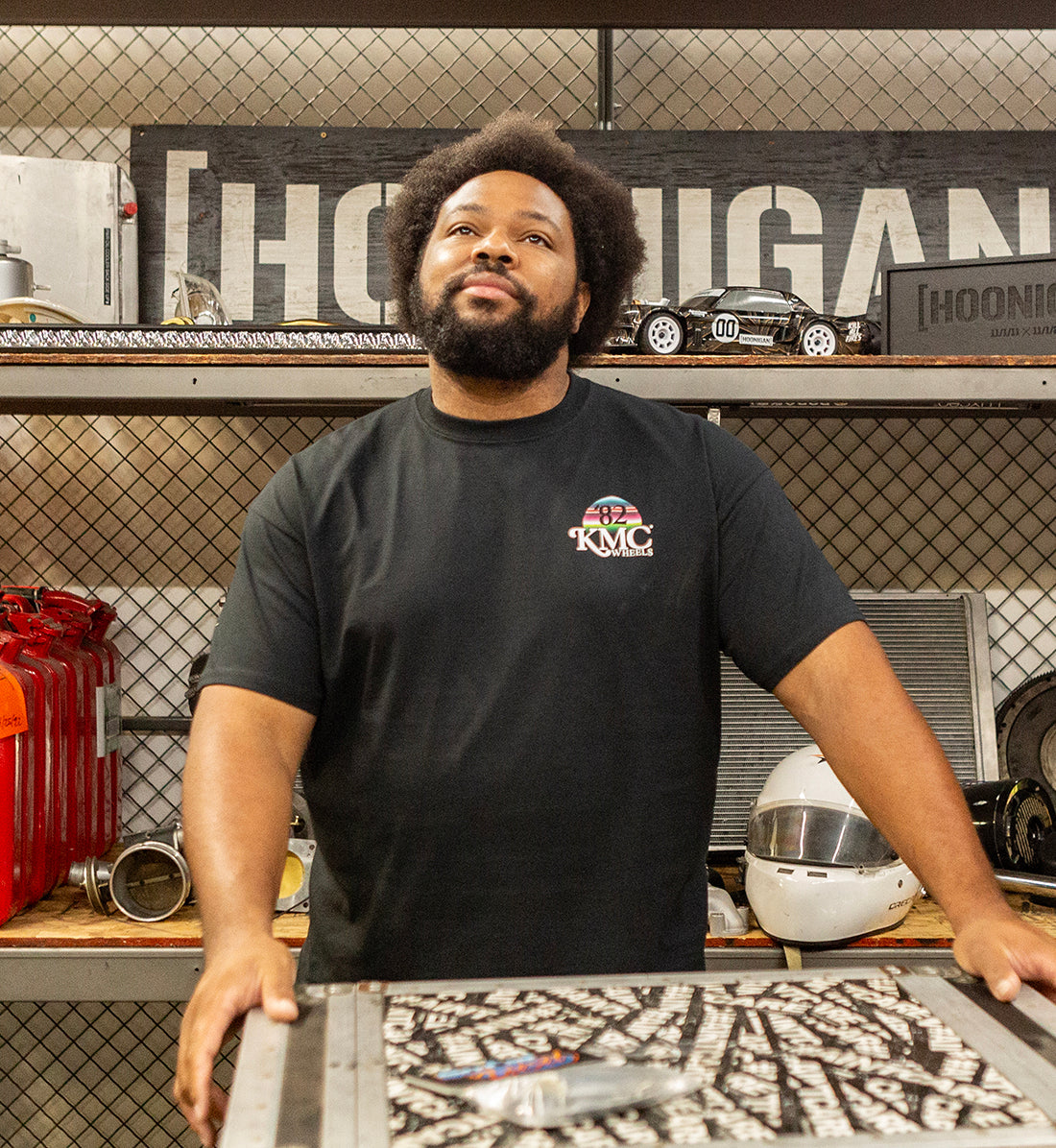 Black KMC DAY ONE Short Sleeve Tee displayed on a model in a casual setting, featuring a clean design and comfortable fit.