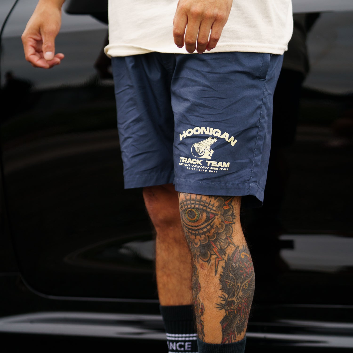 Hoonigan TRACK TEAM Athletic Shorts in black, featuring the Hoonigan logo on the left leg and a comfortable athletic fit.