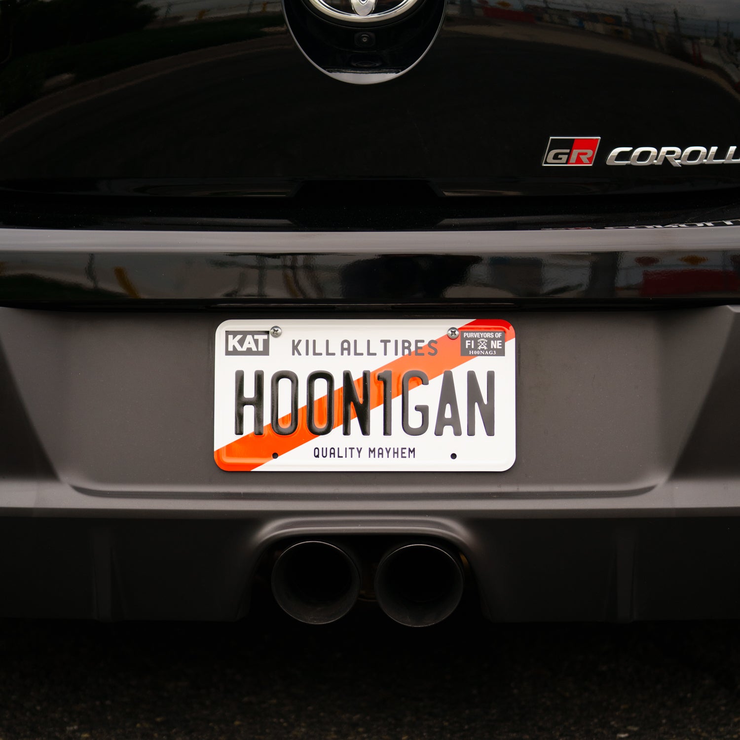 Hoonigan KARI license plate featuring a bold design with the Hoonigan logo and vibrant colors.