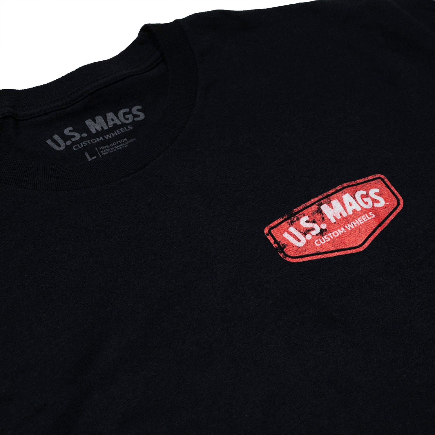 US Mags SHIELD short sleeve tee featuring a bold logo design in a casual style.