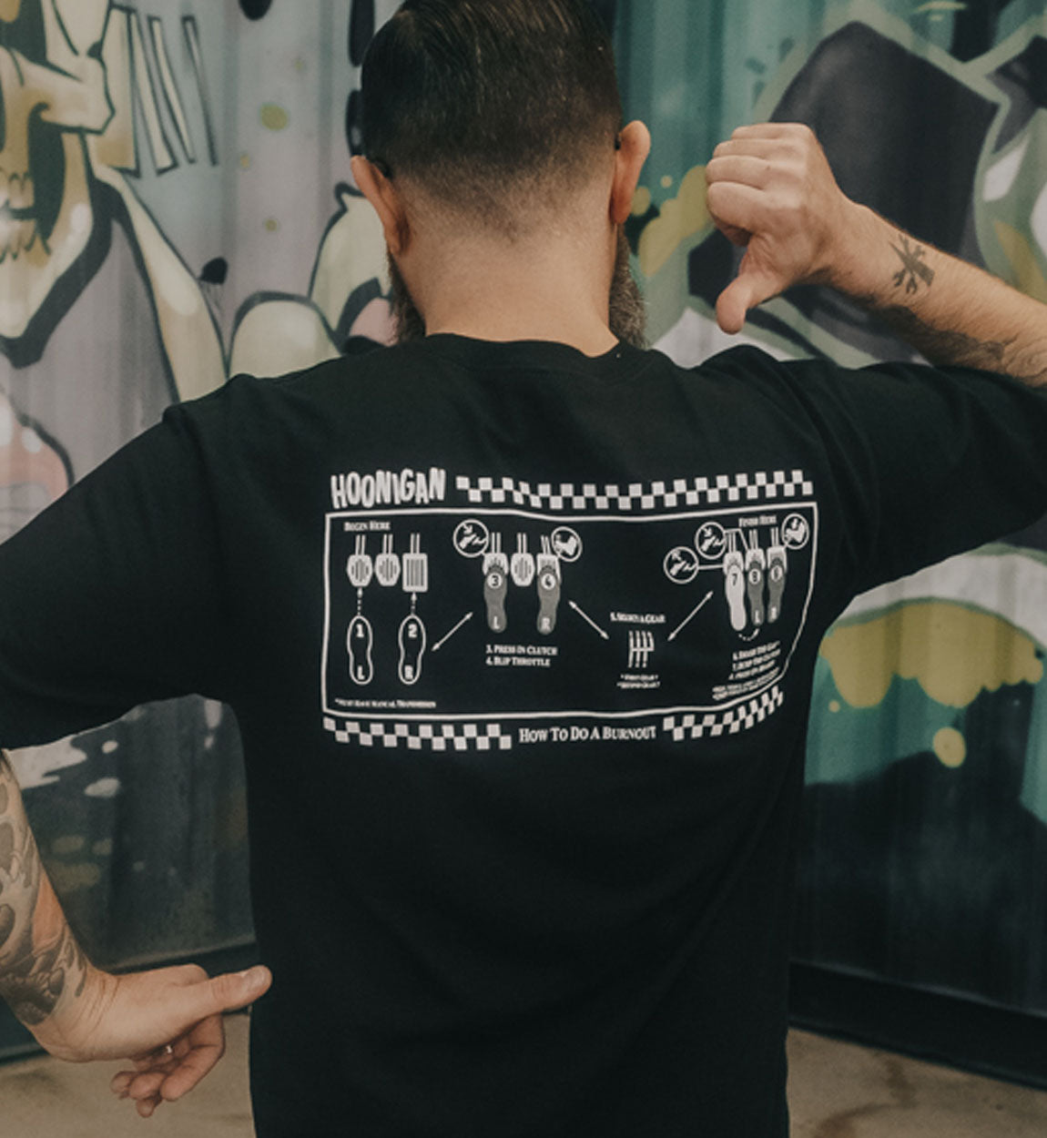 Black Jon Chase Signature Series "How To" short sleeve T-shirt featuring instructional graphics on the back.