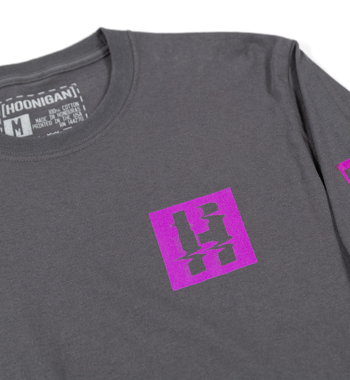 Gray long sleeve tee with a purple glitch-style logo on the chest and a printed label inside the collar.