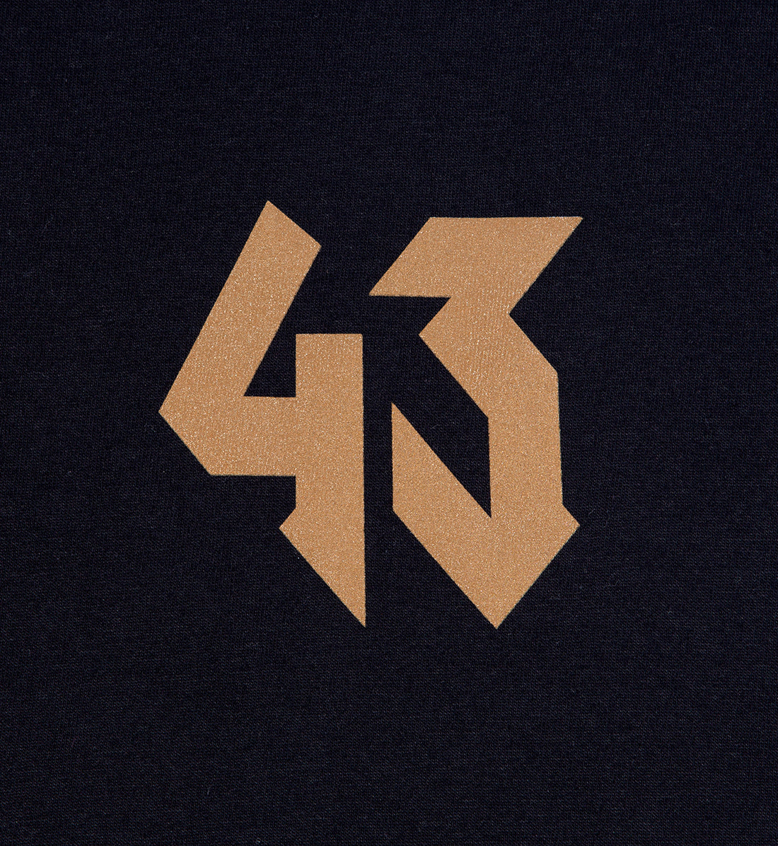 Black short sleeve tee featuring a gold "GYMKHANA7" logo design with bold, angular lettering.